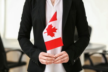 Woman with Canadian flag indoors