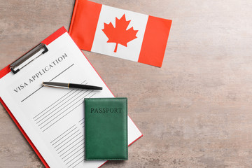 Visa application form, passport and Canadian flag on table. Concept of immigration - obrazy, fototapety, plakaty