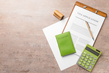 Visa application form, passport, stamp and calculator on table. Concept of immigration