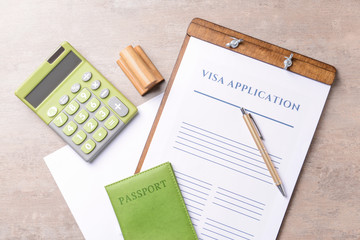 Visa application form, passport, stamp and calculator on table. Concept of immigration