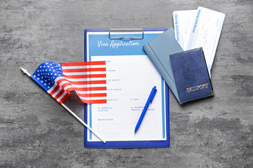 Fototapeta na wymiar Visa application form, documents and USA flag on table. Concept of immigration