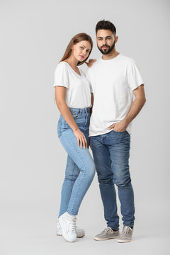 Stylish Young Couple In Jeans On White Background