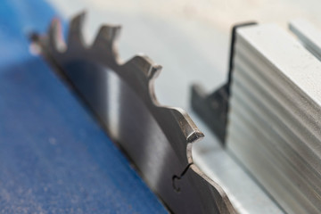 Table saw blade tooth close up macro shot , image for industrial background.