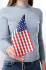 Woman with USA flag indoors
