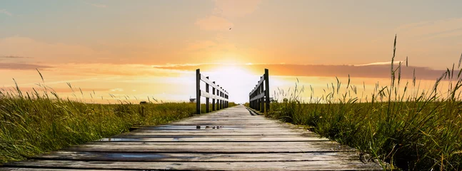 Poster Panoramische houten pier Noordzee in de zonsondergang © Animaflora PicsStock