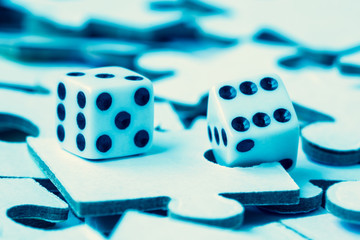 Dice on the pile of jigsaw puzzles
