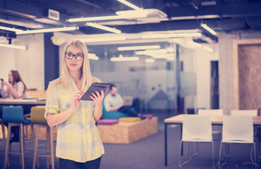 blonde businesswoman working online using digital tablet