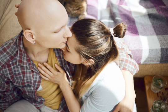 inloved people show tender feelings for each other, woman affectionate touching a man chest by the hand and touches his face by own. young tender enamoured couple spending time together at home