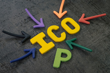 ICO, Initial Coin Offering concept, colorful arrows pointing to the word ICO at the center with P on chalkboard wall, the cryptocurrency equivalent to an IPO in the mainstream investment