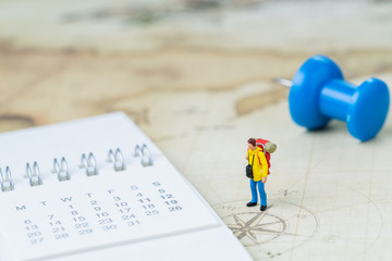 Travel, tourism, vacation or wanderlust life concept, miniature young man backpacker standing on...