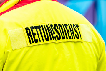 Rettungsdienst sign (English: ambulance service) on the back of a paramedic yellow jacket