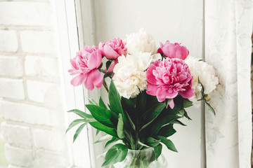Beautiful pink and white peonies bouquet at rustic old wooden window. Floral decor and arrangement. Gathering flowers. Rural still life, countryside. Happy mothers day