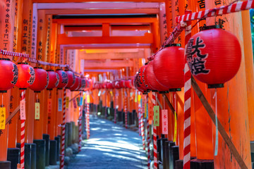 Fushimi Inari-taisha Shrine. Thousands countless vermilion Torii gates with red Japanese lanterns,...