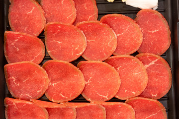 Pork, beef, slides placed in the tray served, at the restaurant.