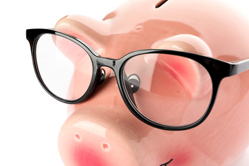 Happy piggy bank with glasses isolated on white background, closeup. Finance, saving money