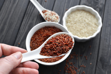 hand holdind a spoon with red and steamed rice mix