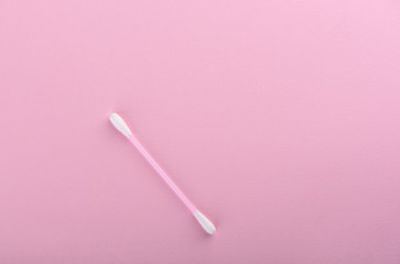 Cotton buds over a pink background. Hygienic supplies.