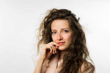 pretty girl with long curly hair in a pink jacket on a white background