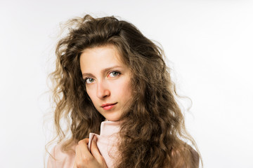 Naklejka premium pretty girl with long curly hair in a pink jacket on a white background
