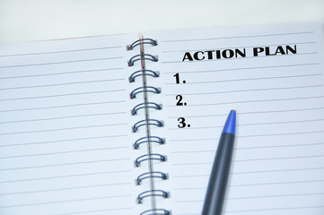 ACTION PLAN text on notebook.