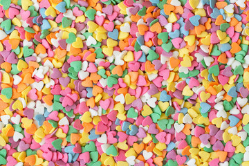 Fototapeta na wymiar Сolorful round sprinkles or sugar confetti on white background. Sugar sprinkle dots, decoration for cake and bakery. 