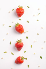 Strawberry creative pattern. Ripe red berry with green leaves on white background