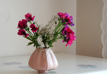 bouquet of flowers in a vase on wooden table