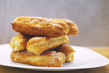 eclairs cakes lie on a white plate.  sweet cakes eclairs