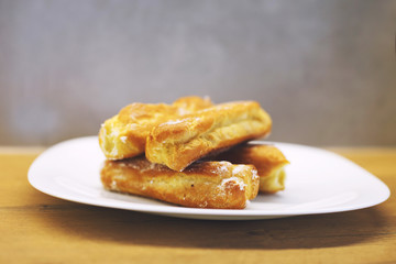 eclairs cakes lie on a white plate.  sweet cakes eclairs
