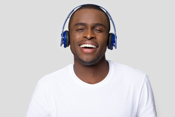 African male laughing enjoy music listening using headphones