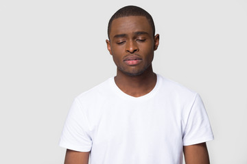 Head shot sad african male studio portrait on grey background