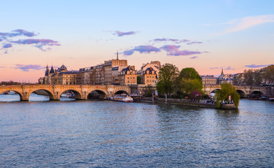 The oldest bridge ( Pont Neuf ) across Seine River and historic buildings of Paris France at sunset. April 2019