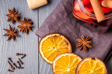 Mulled wine and spices on gray wooden background. Selective focus. Top view.