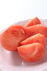 Cut tomato on dish with copy space