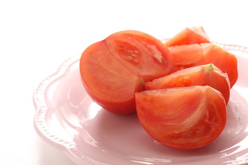Cut tomato on dish with copy space
