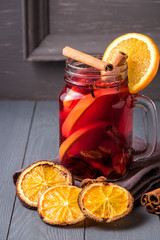 Mulled wine and spices on gray wooden background. Selective focus.