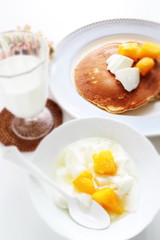 Peach and yogurt on bowl
