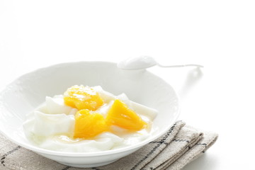 Peach and yogurt on bowl