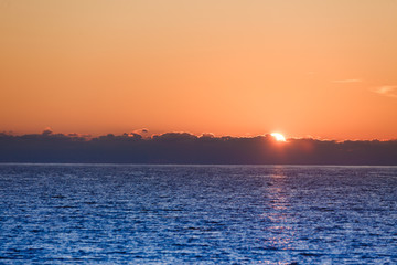 Sunrise or sunset over sea surface