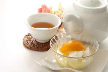 Chinese dessert, peach and almond tofu on glass bowl