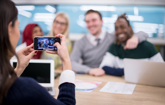 businesswoman using mobile phone for taking photo