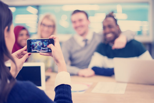 Businesswoman Using Mobile Phone For Taking Photo