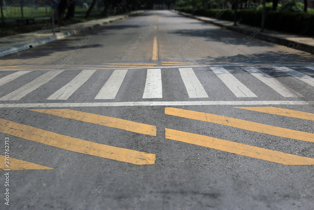 Wall mural crosswalk street in urban area with flare of sun light, zebra crosswalk in town for safety people wa