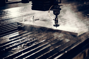 Water jet cutter machine cutting steel plate