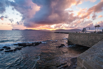 Sunset/Dusk along the sea front of Alghero (L'Alguer), province of Sassari , Sardinia, Italy. ...