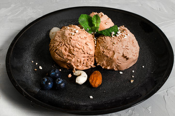 Set of ice cream scoops of different colors and flavours with berries, nuts and fruits