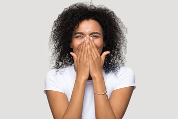 Happy excited african woman isolated on grey blank background