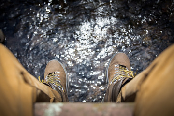 hiking shoes above a river