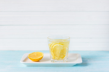 Lemon water in a glass on a white background. selective focus. healthy morning drink