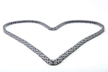 heart made of car engine chain on a white background. heart of timing chain of gas distribution mechanism